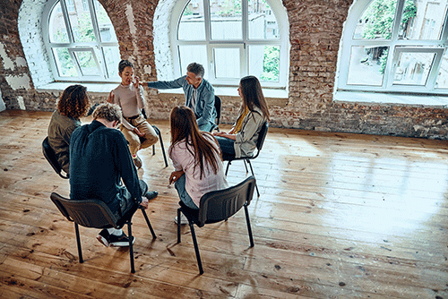 People in an addiction treatment program sitting in a circle