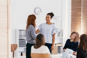 client and therapist discuss positive self-image in women's rehab in a group